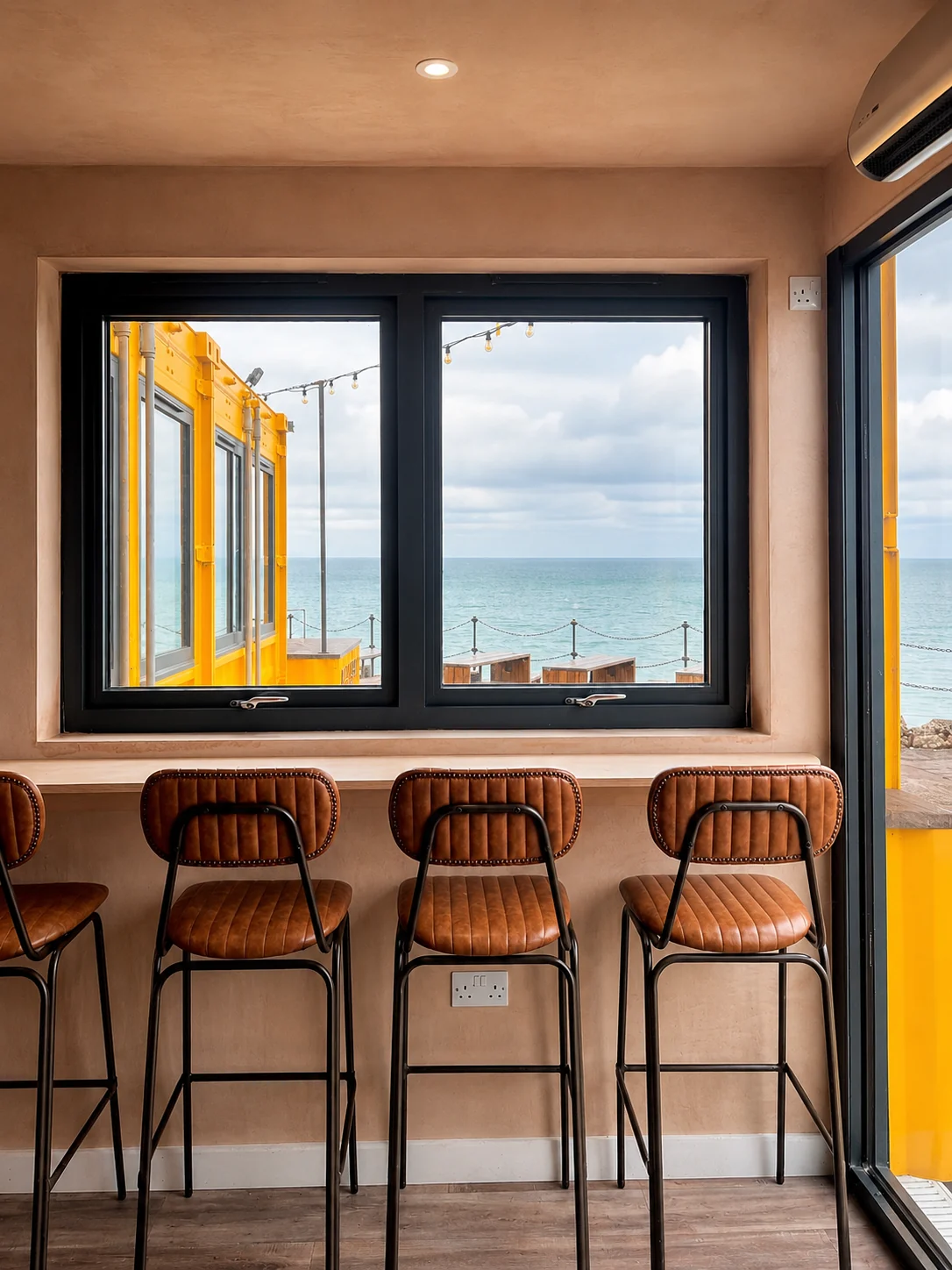 Window seating looking out across Folkestone Harbour from Sailbox