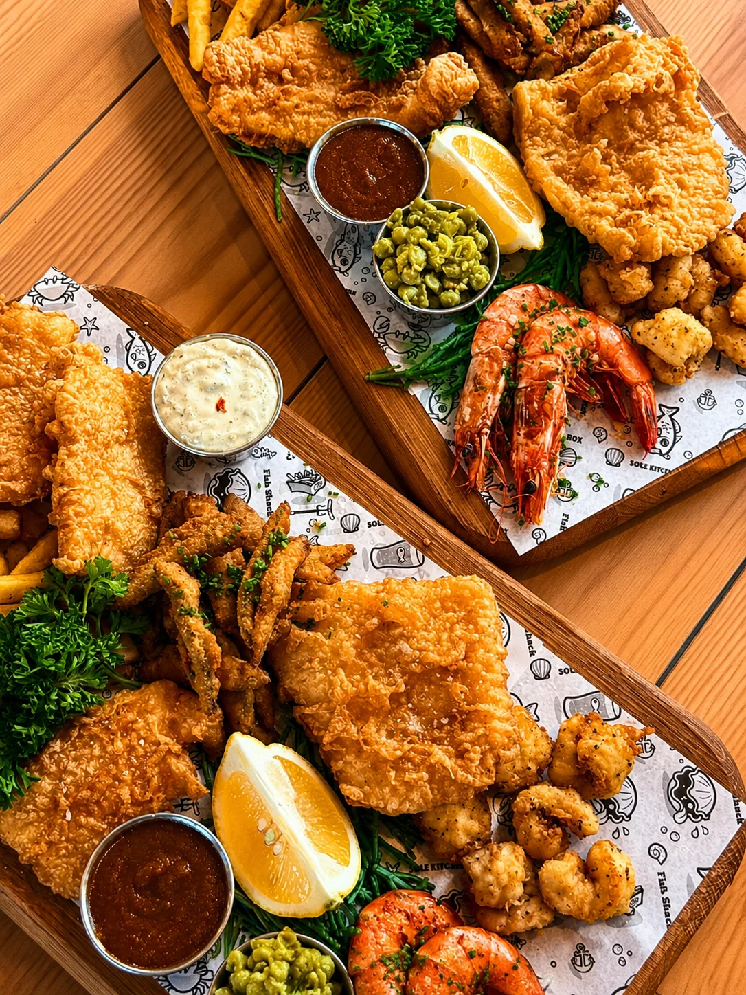 Seafood sharing platters on a wooden Sailbox table