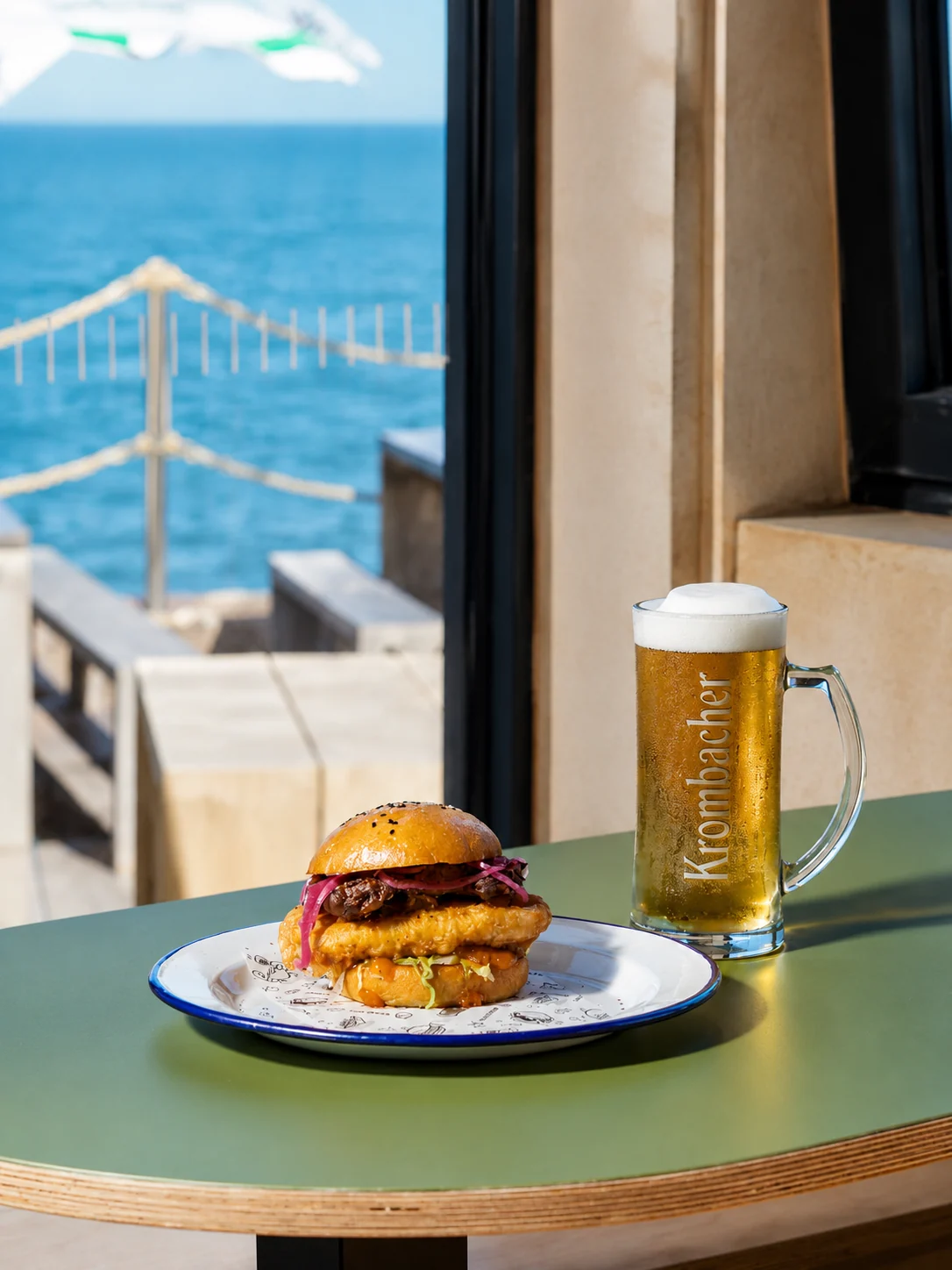 A Sailbox burger and beer beside the sea