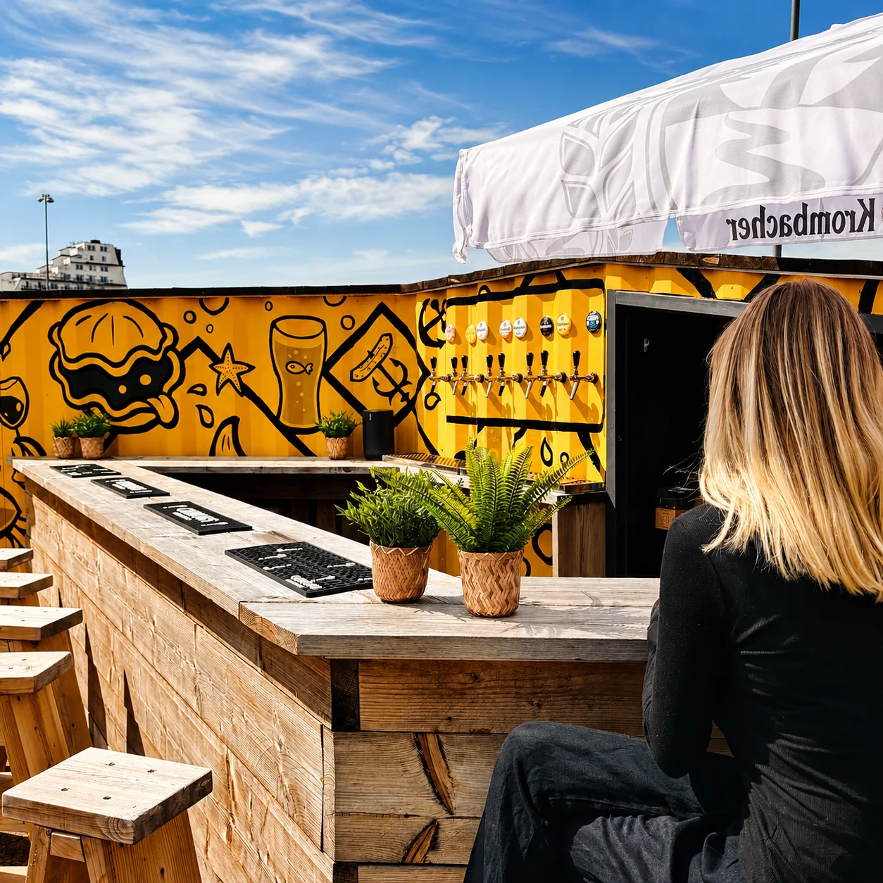 The outdoor Sailbox bar against its illustrated yellow container